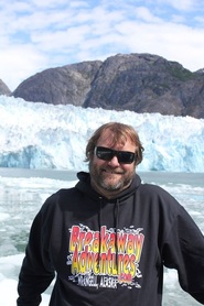 a man standing in front of a mountain